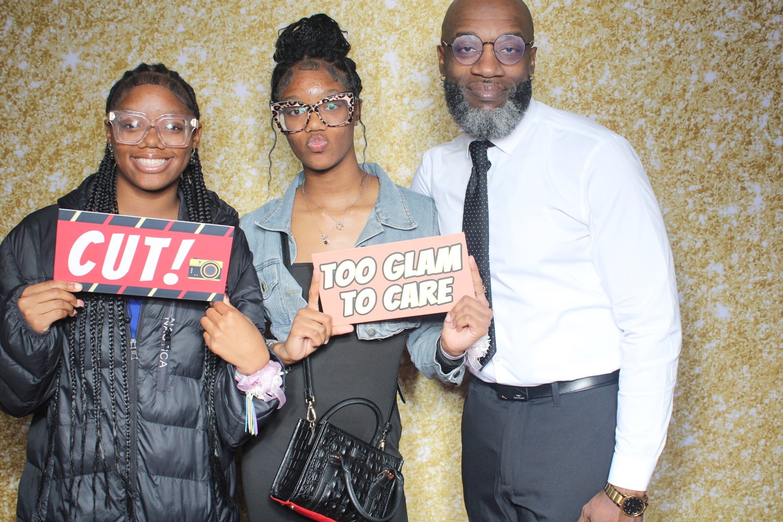 Family guests posing with playful signs at a father daughter celebration