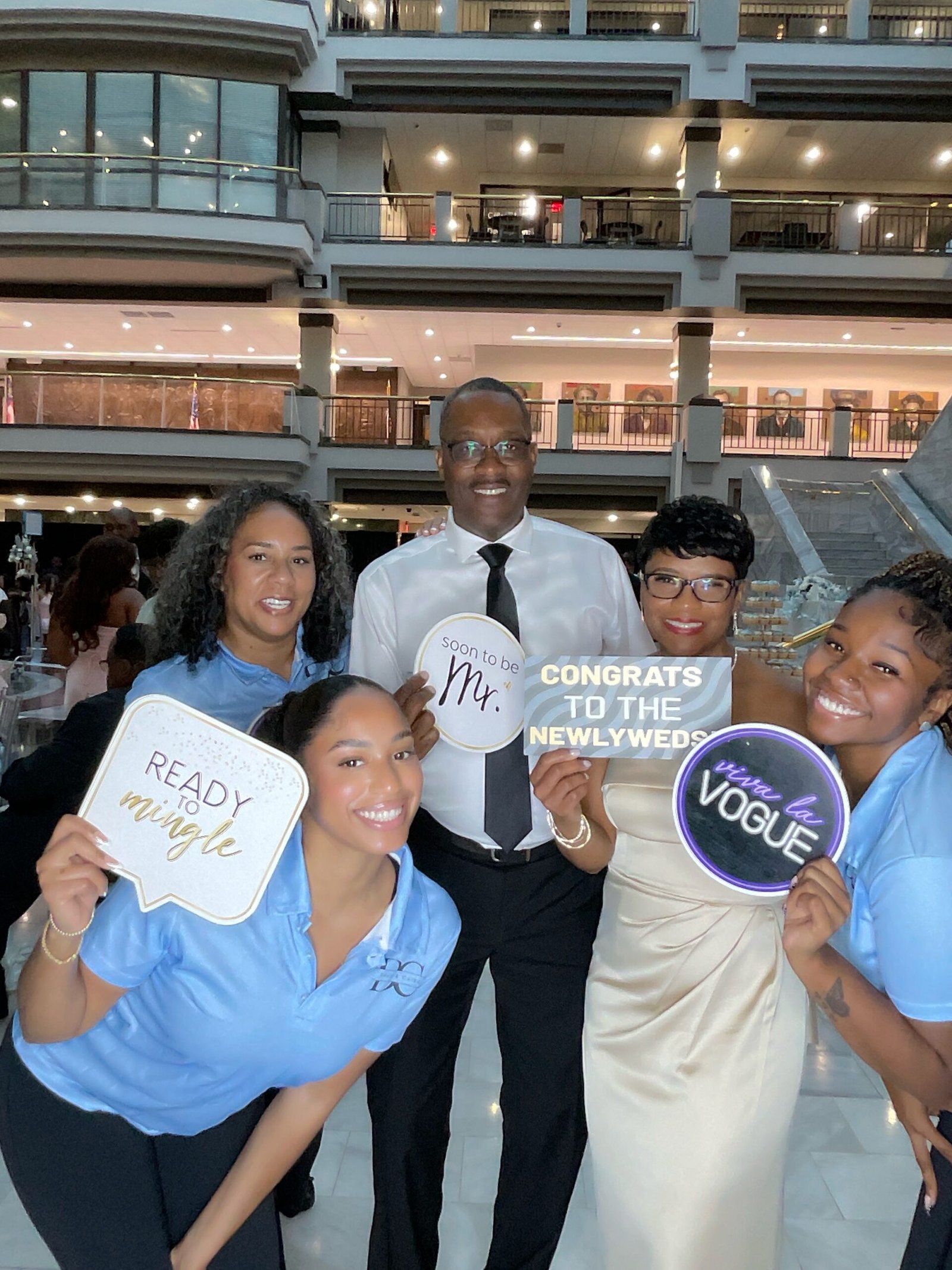 Guests at an iPad photo booth event holding playful signs
