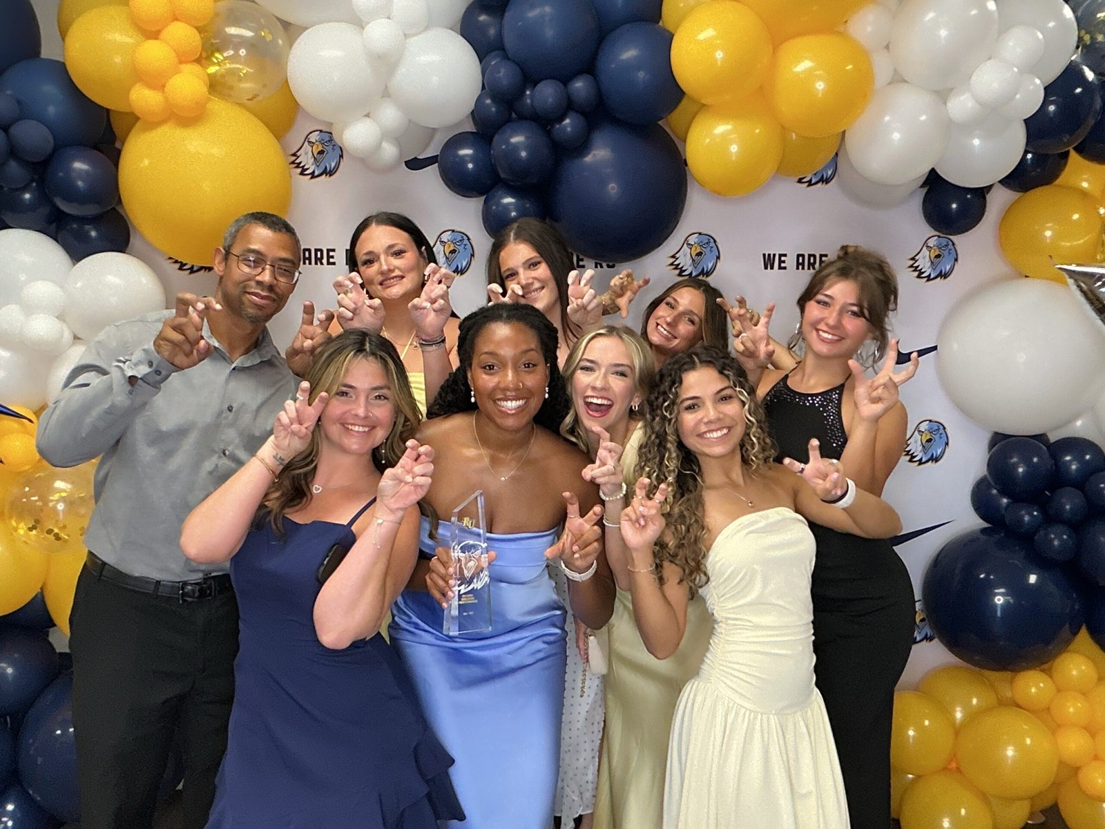 Reinhardt University awards guests celebrating beneath navy, gold and white balloons
