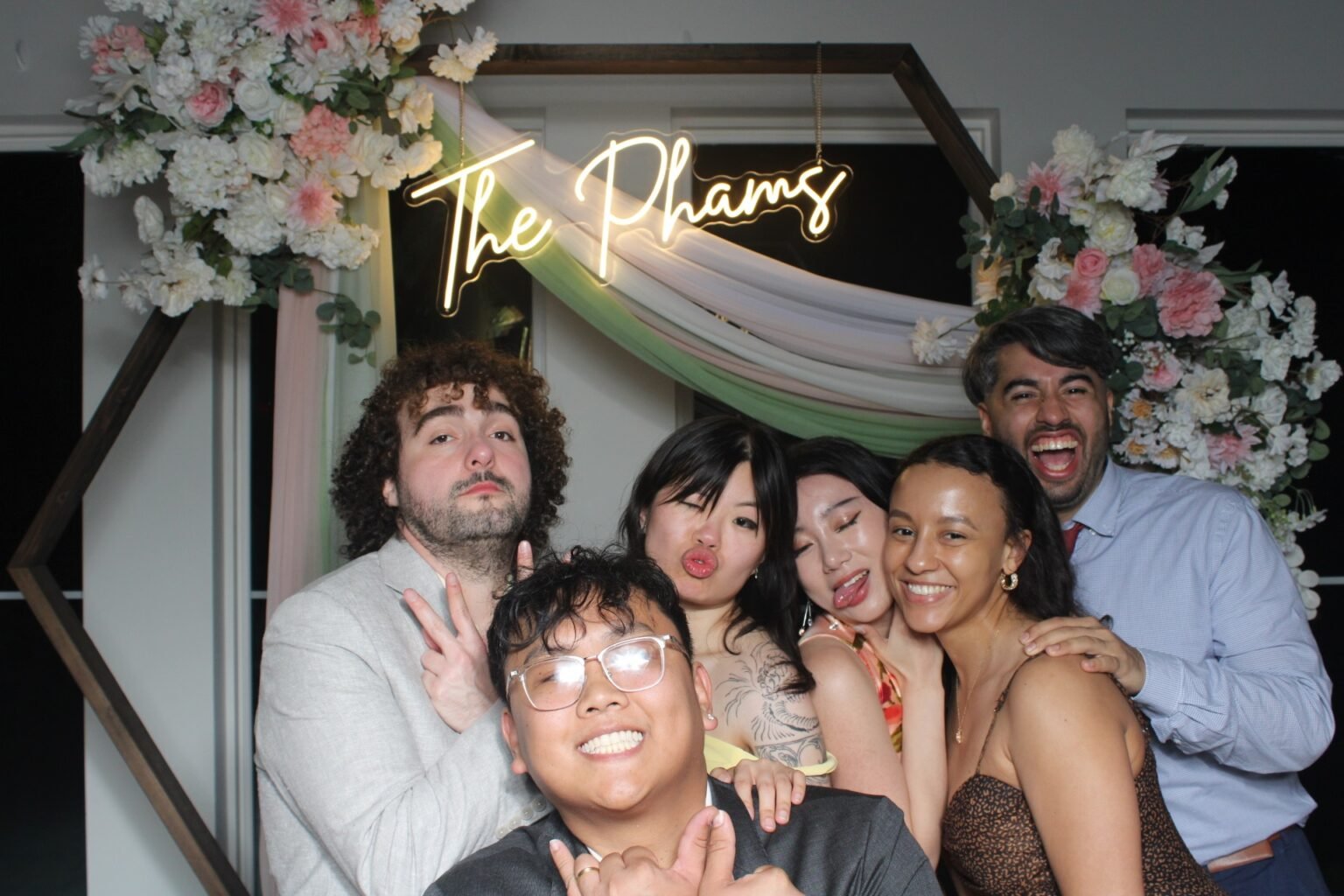 Guests having fun together at Vinh and Cindy's wedding photo booth